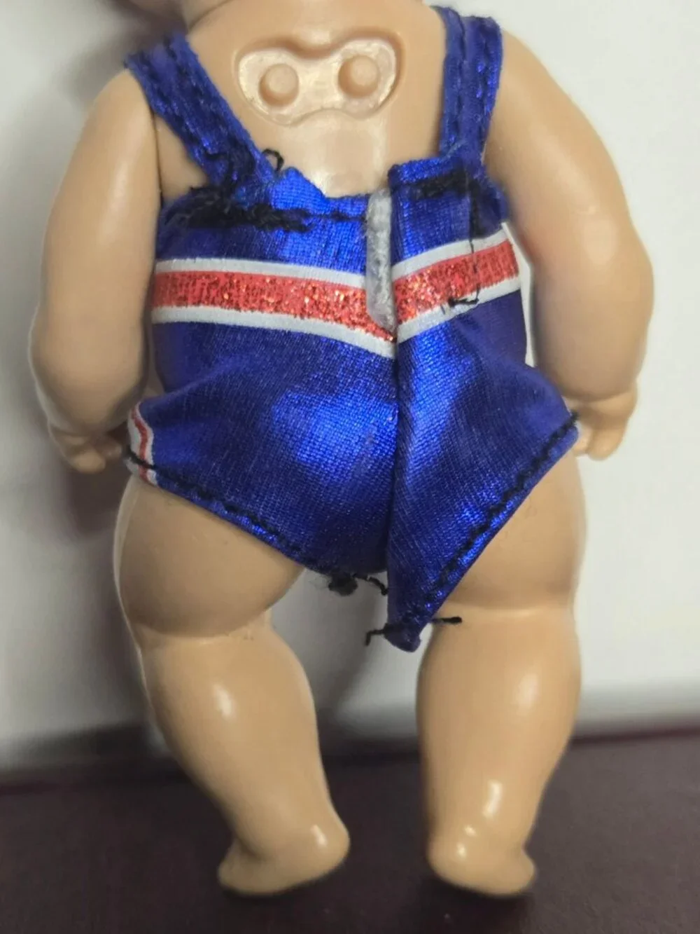 Zapf Creations Baby Born Mini Surprise Doll With Union Jack Swimsuit